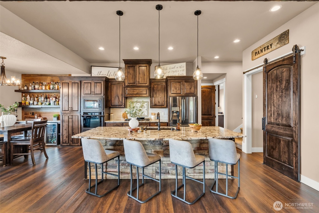 Open chef's kitchen with granite island and custom cabinetry